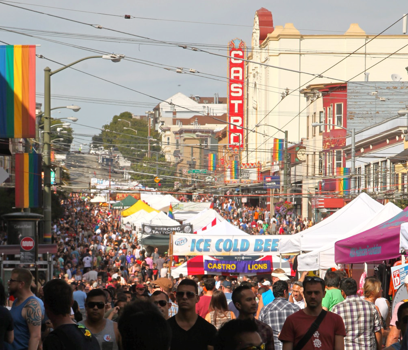 castrovintage Crowd at Castro Street Fair with rainbow flags and vendor tents visible.